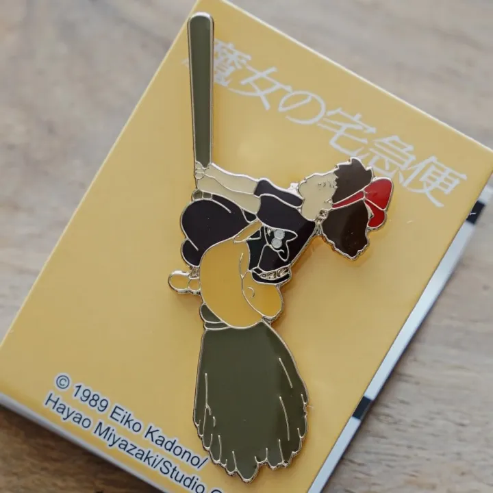 Pins Kiki on her broom - Kiki's Delivery Service